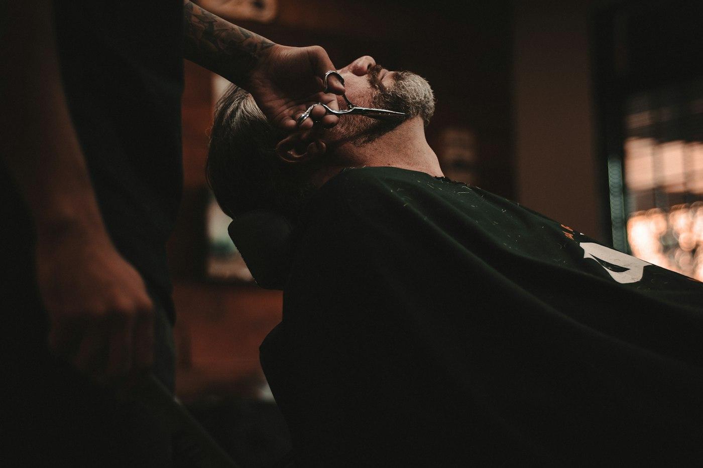 A close beard and haircut being finished