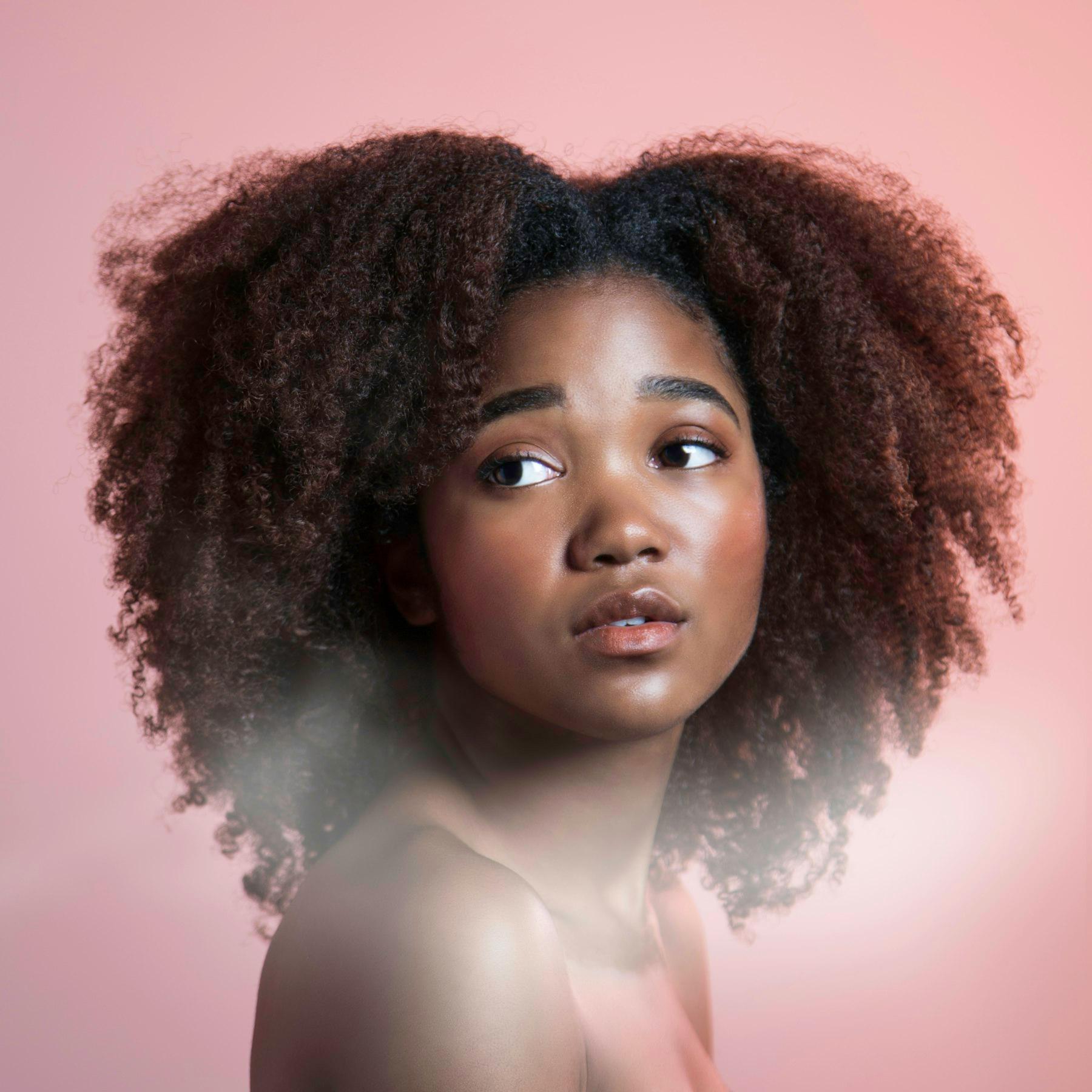 An editorial portrait with natural makeup and considered hair