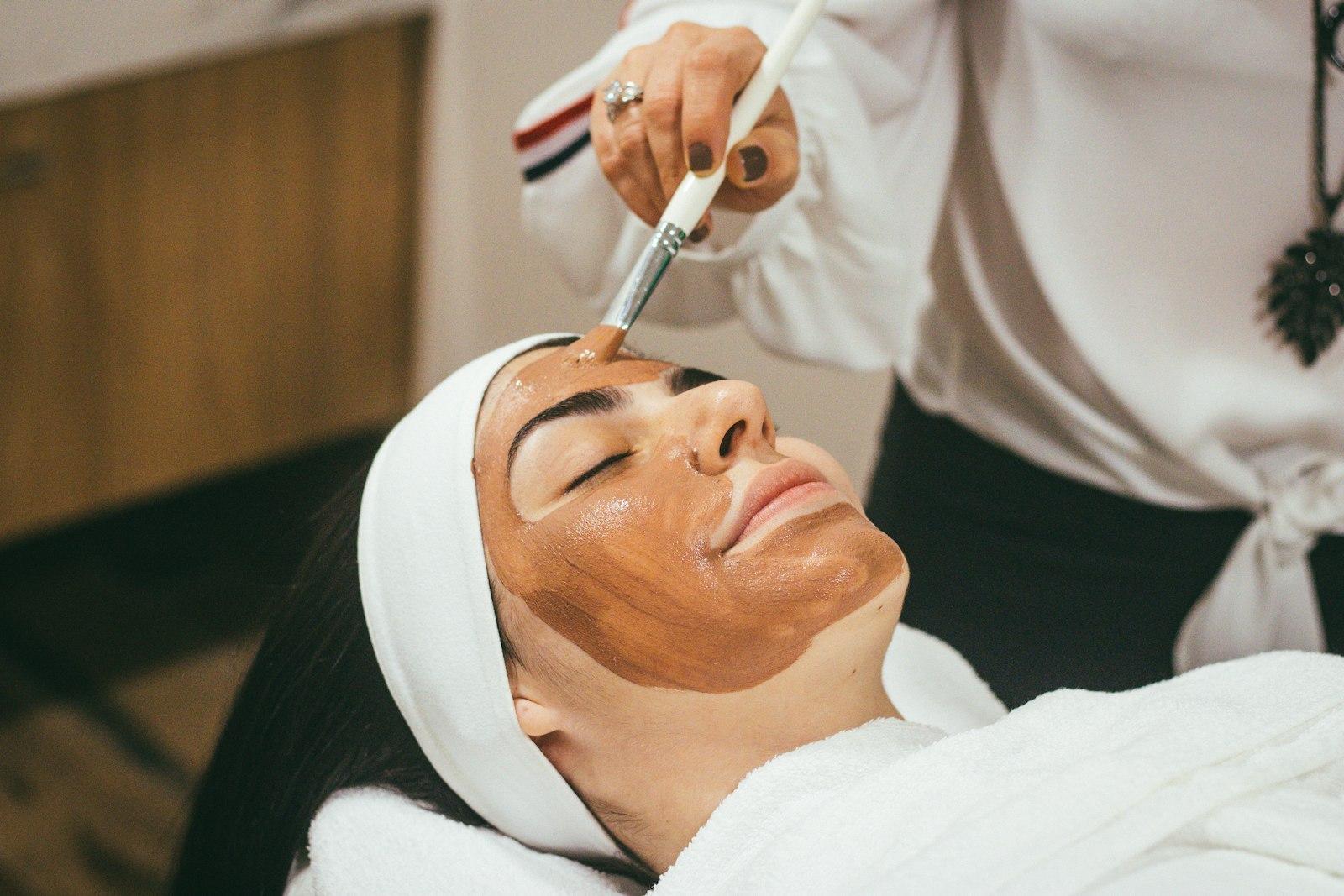 A professional facial being applied in a treatment room